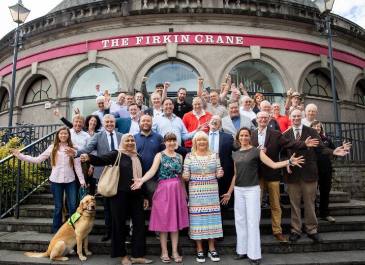 A group of people standing on the steps outside a building in Cork city at the launch of the EPA and An Taisce Clean Air Together Project. There is also a dog.