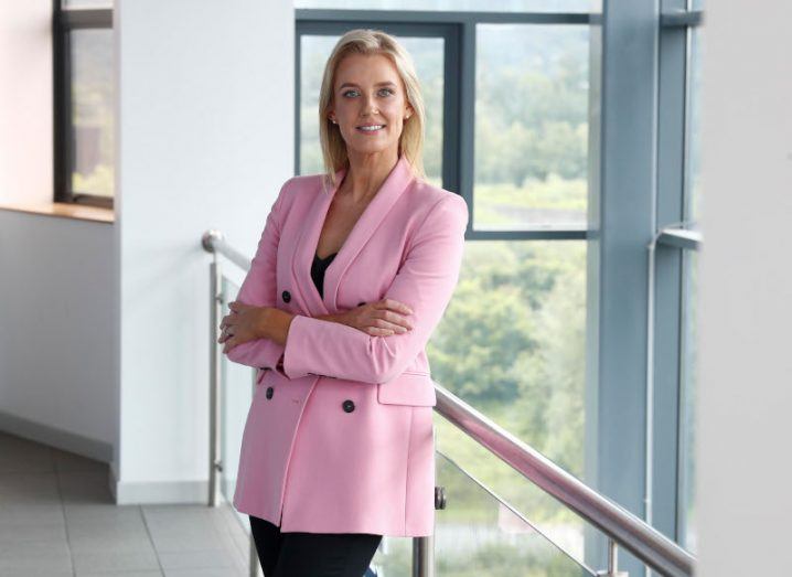Martina Hennessy, managing director, Doddl.ie standing at the top of a staircase with windows behind her.