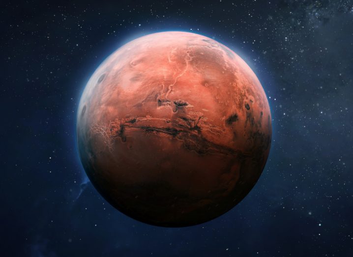 An image of the planet Mars with space and stars visible in the background.
