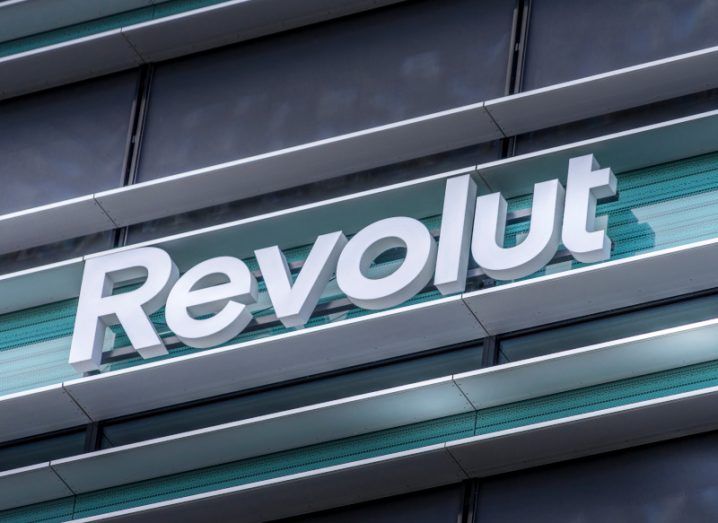 Revolut logo on a signboard on a building wall.