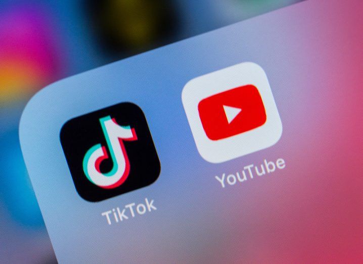 A mobile phone screen with the YouTube and TikTok app logos next to each other.
