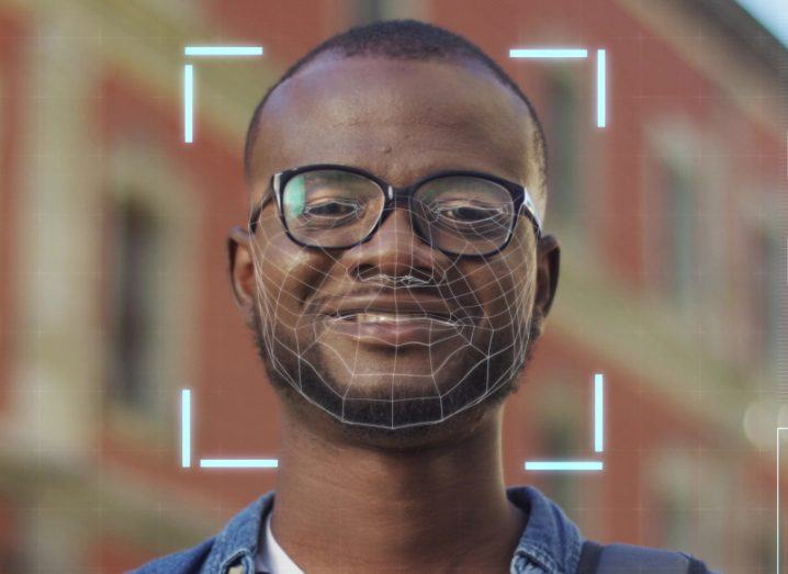 A man looking at the camera with a square box around his head and lines around his face. Used to represent facial editing software.