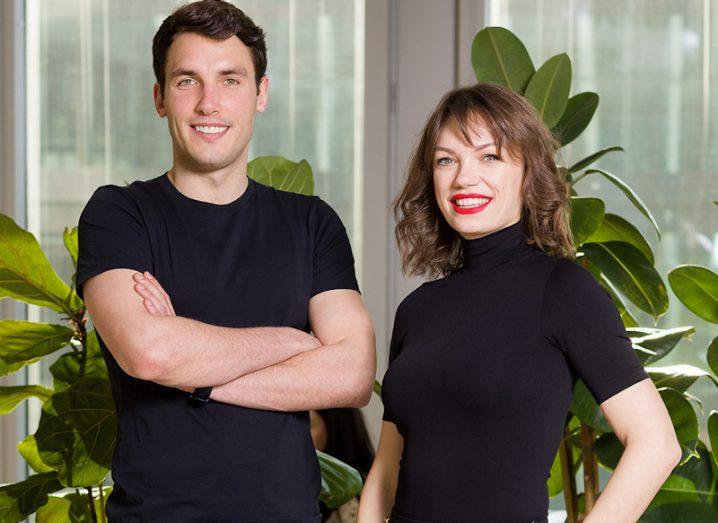 A man and a woman dressed in black stand in front of some plants. They are the founders of Polish start-up Data Lake.