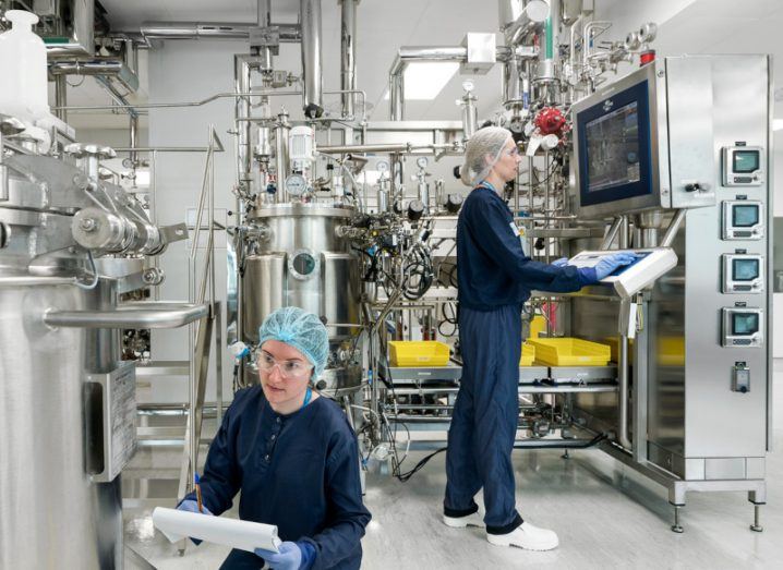 Staff members working at NIBRT facility in a medical manufacturing setting.