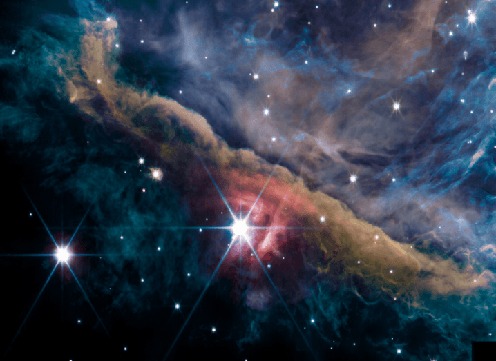 An image of a part of the Orion Nebula, showing bright stars and gasses. Taken from the James Webb Space Telescope.
