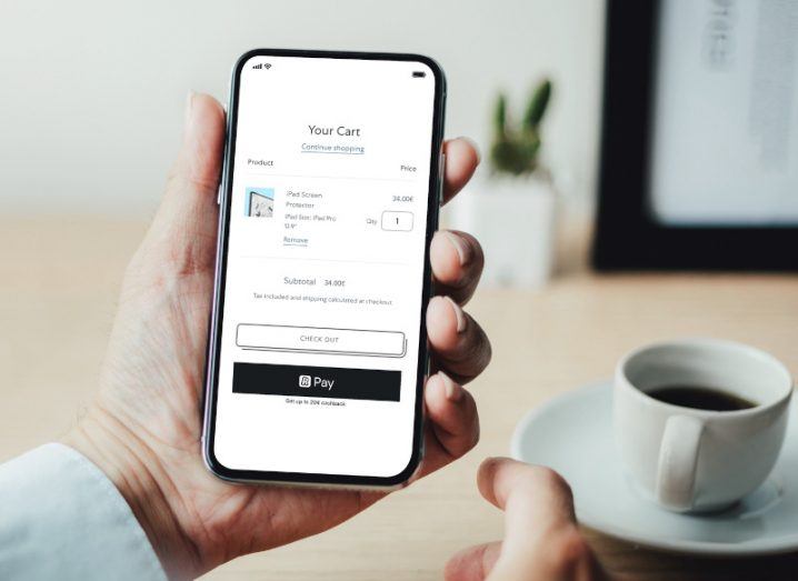 Revolut Pay opened on a person's phone with a cup of coffee in the background.