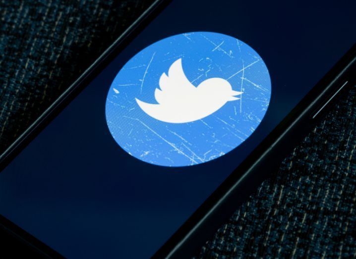 A Twitter logo on a smartphone screen.