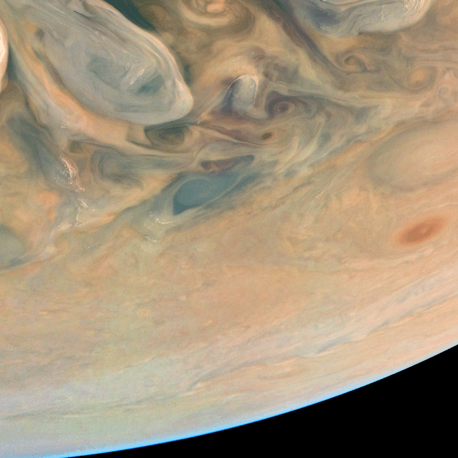 Enhanced image of the surface of Jupiter with vibrant coloured patterns and the horizon visible in the bottom right corner.