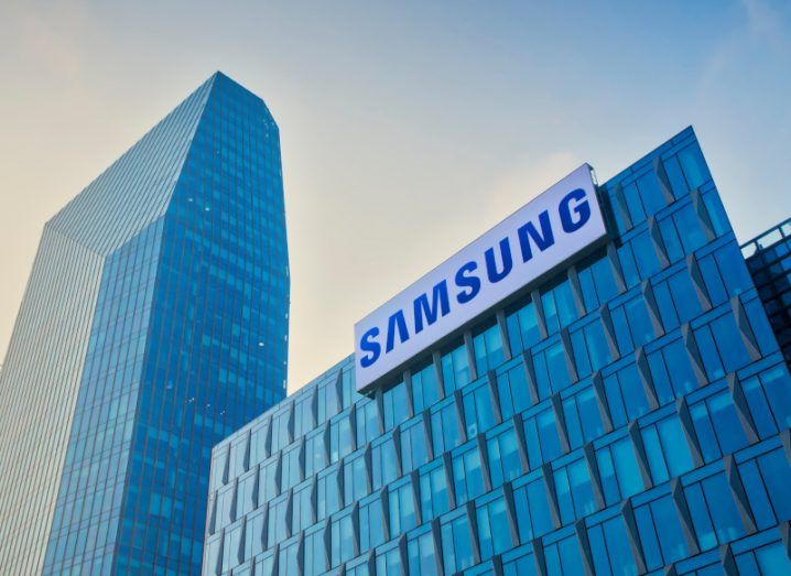 Samsung logo on a building with another taller building rising in the background.