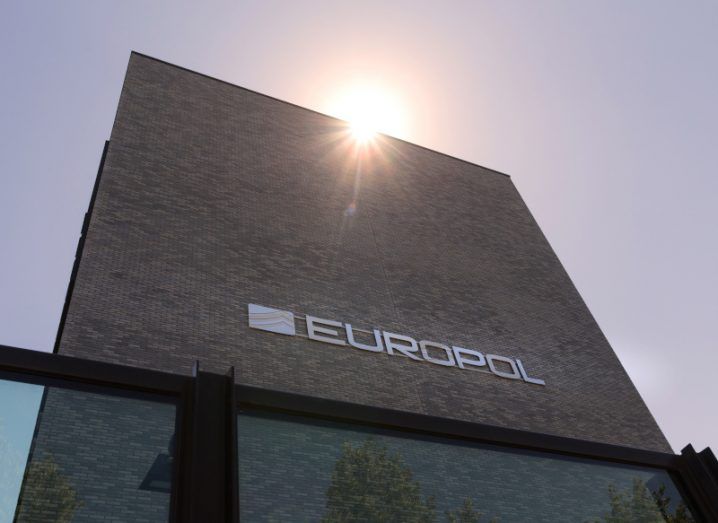 Europol logo on a building with sun shining in the backdrop.