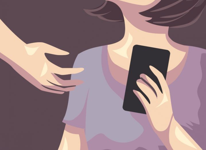 Illustration of a hand reaching out to take a mobile phone from a woman. Used to represent digital domestic abuse.