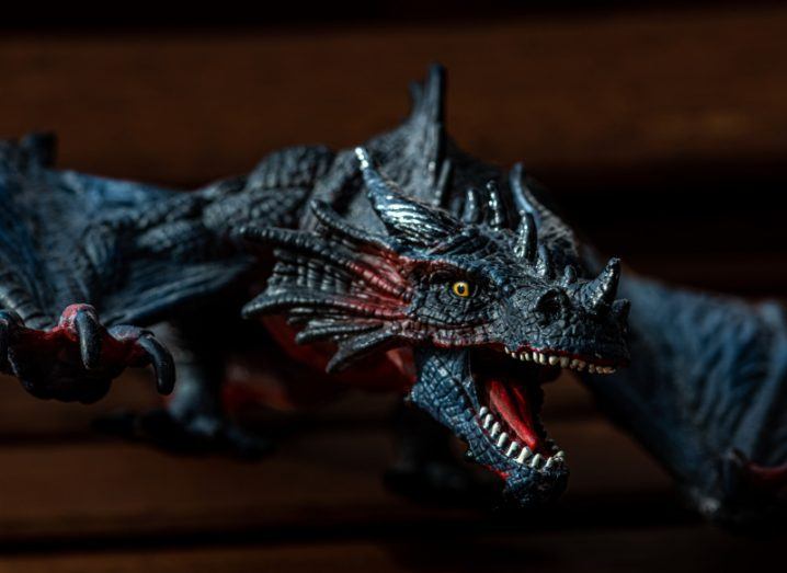 Close-up of a detailed model of a dragon with its mouth open as if roaring.