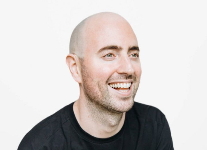 Headshot of Intercom CEO Eoghan McCabe, looking off-camera and smiling.