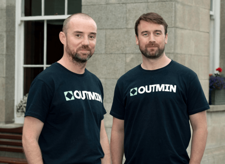 Outmin founders Ross Hunt and David Kelleher standing next to each other wearing Outmin branded T-shirts.