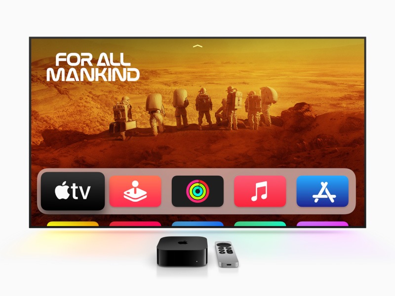 A TV screen with the Apple TV 4K device and remote kept in front of it.