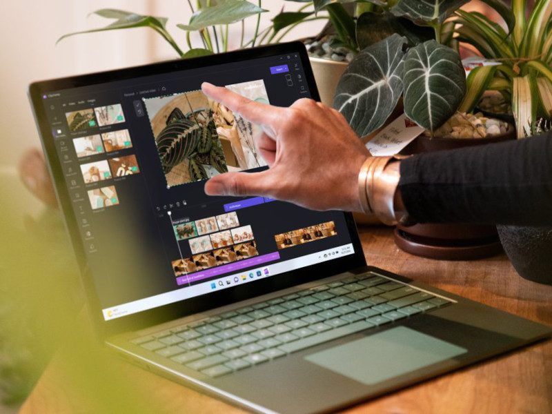 A person's hand is touching the screen of the new Surface 5 laptop.