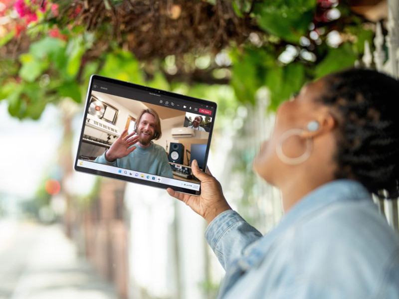 A person on a video call holds up the new Surface Pro 9 tablet.