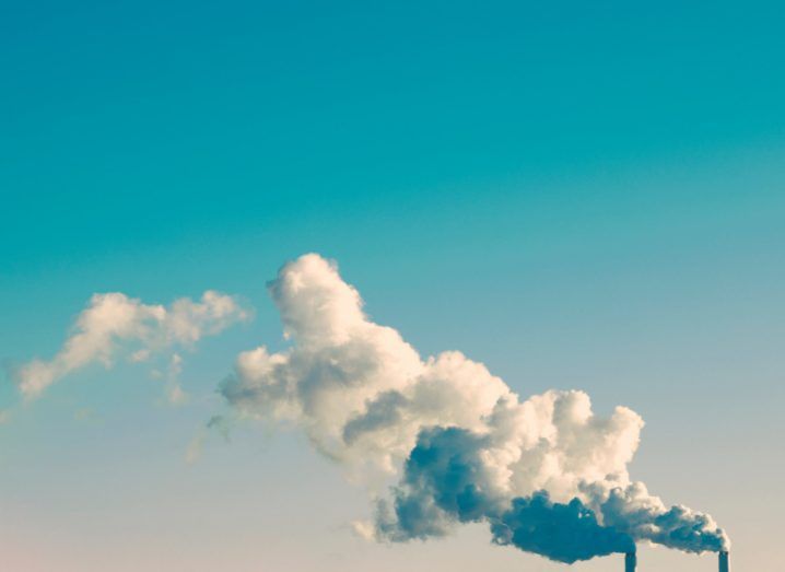 Emissions from energy stream into a bright blue sky.