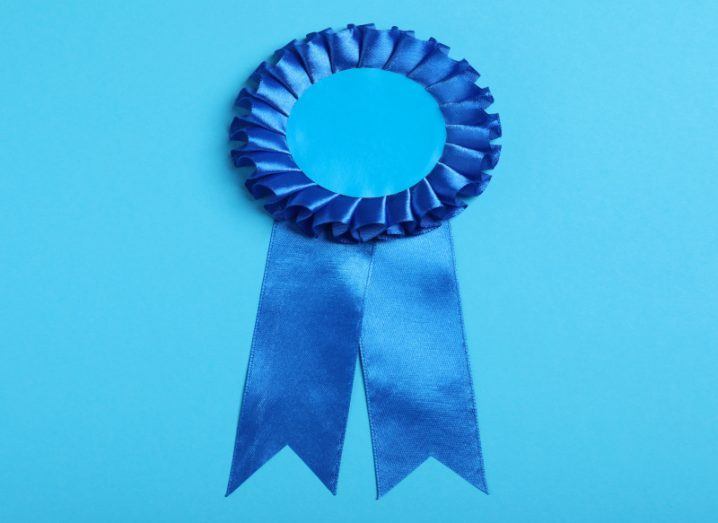 Blue rosette ribbon on a light blue background.