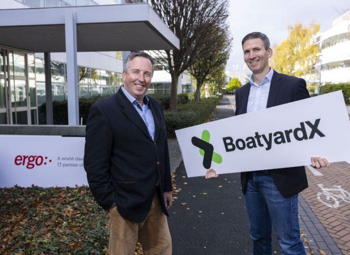 Paul McCann of Ergo and Brian Barter of BoatyardX stand in front of an office.