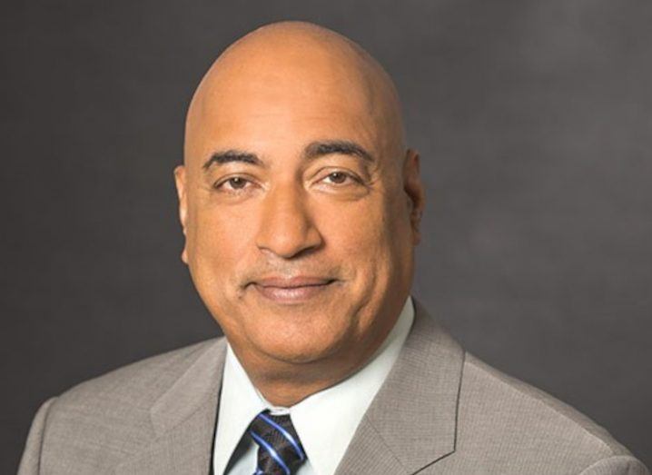 Headshot of Randhir Thakur, president of Intel Foundry Services, wearing a grey suit and multicoloured tie.