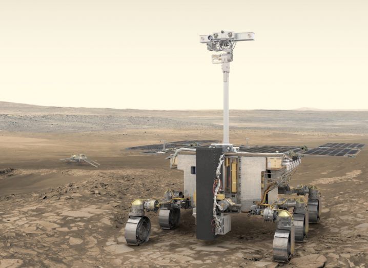 The Rosalind Franklin Mars rover concept image. A WALL-E lookalike robot stands in the middle of a deserted area that looks like the surface of Mars.