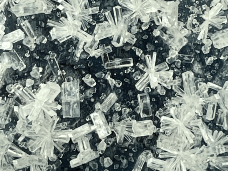 Close-up of tiny crystals in various random shapes and patterns.