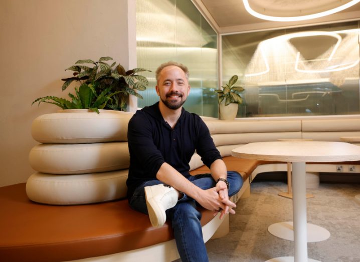 Drew Houston sits on a curved bench seat in Dropbox’s Dublin Studio.