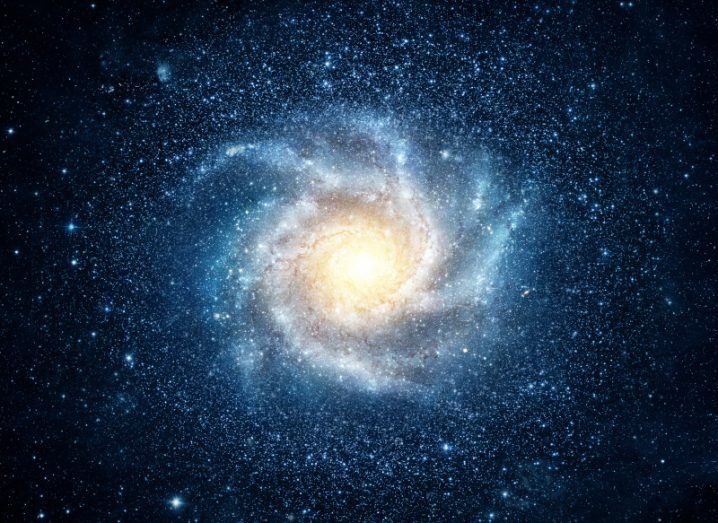 Illustration of a spiral galaxy centred around a star, much like the Milky Way.