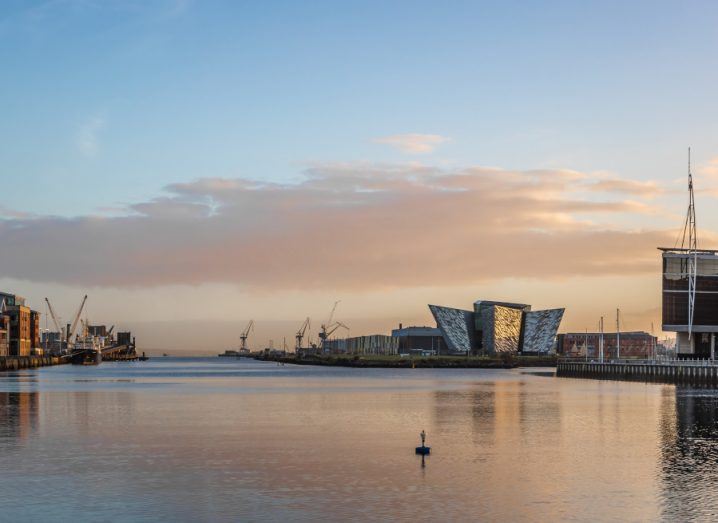 Belfast city skyline with buildings and river visible.