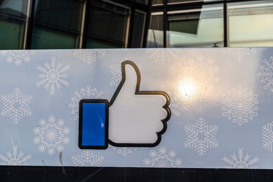 Facebook’s 'thumbs up’ logo on a sign outside an office building.