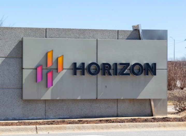 Horizon Therapeutics logo on the side of a wall, with a blue sky in the background.