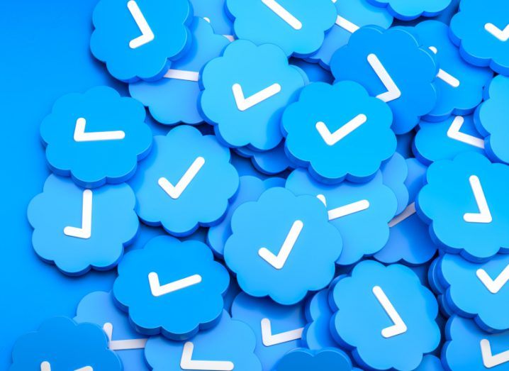 A group of Twitter blue ticks in a blue background. The ticks are used to show if an account is verified on the platform.