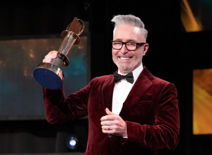 Martin McKay of Texthelp holds up his award for EY Entrepreneur of the Year 2022.