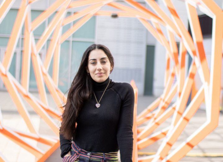 Gabriela Hersham of Huckletree stands in the middle of a spiral wooden spiral structure at the Web3 hub in London.