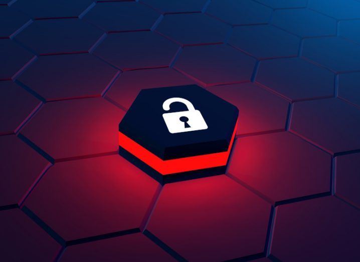 An open padlock sitting on a red hexagon symbol, symbolising cyberattacks.