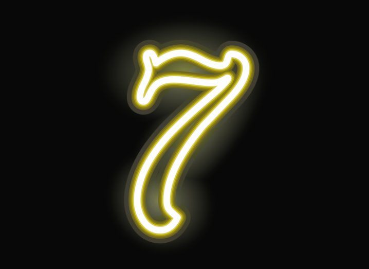 A gold number seven, lit up on a black background,
