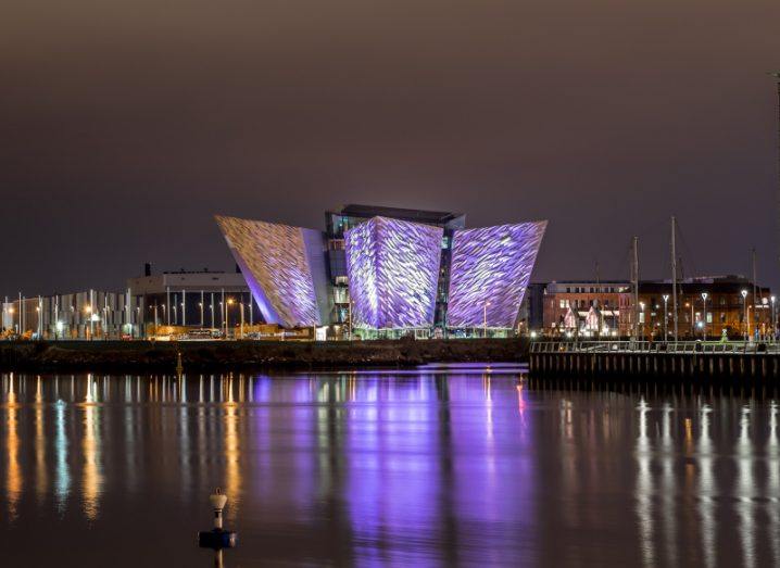 The Titanic Museum lit up in purple at night.