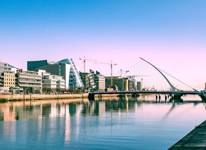 Dublin city skyline with the River Liffey and Samuel Beckett bridge visible.