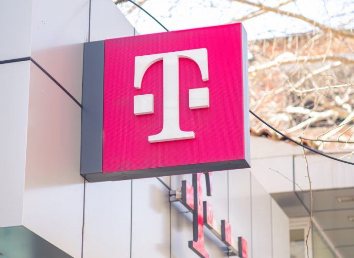 The T-Mobile logo on a pink sign, sticking out from the side of a wall.