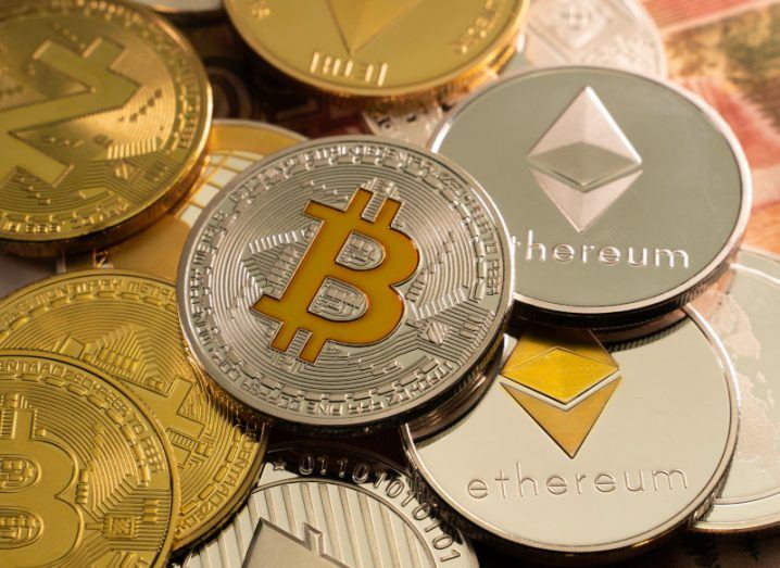 Multiple crypto coins such as bitcoin and ethereum lying on a table.