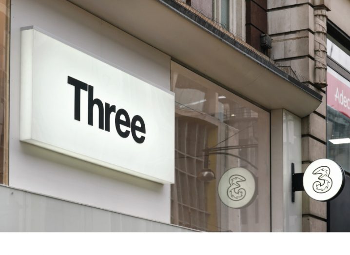 The logo of telecoms company Three is visible on a shopfront building.