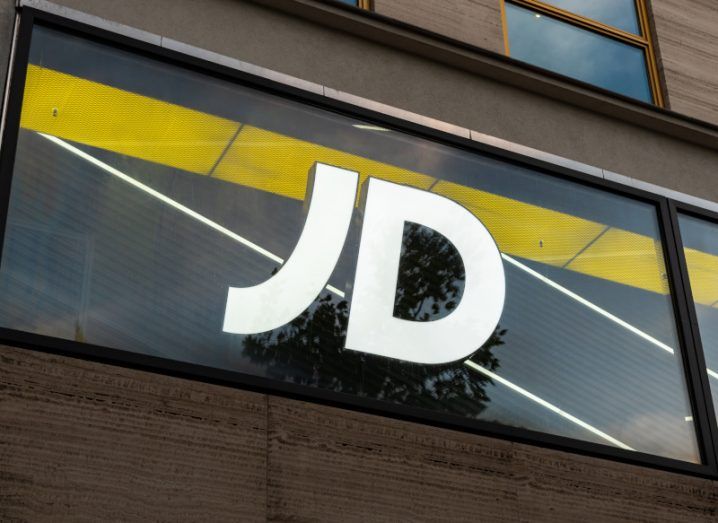 JD Sports logo on a window, on the outside of a building.