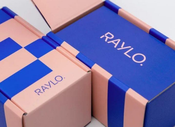 Two purple and pink coloured boxes with the Raylo logo on them.