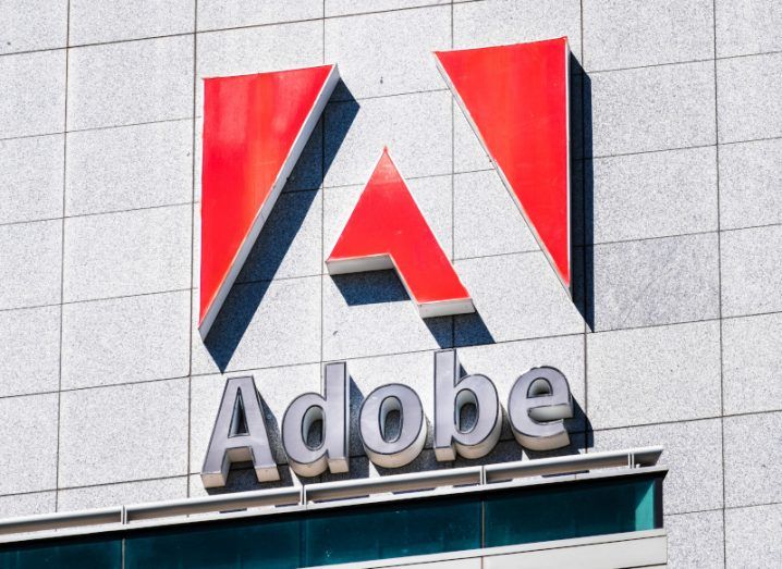 The Adobe logo on the side of a grey building wall.