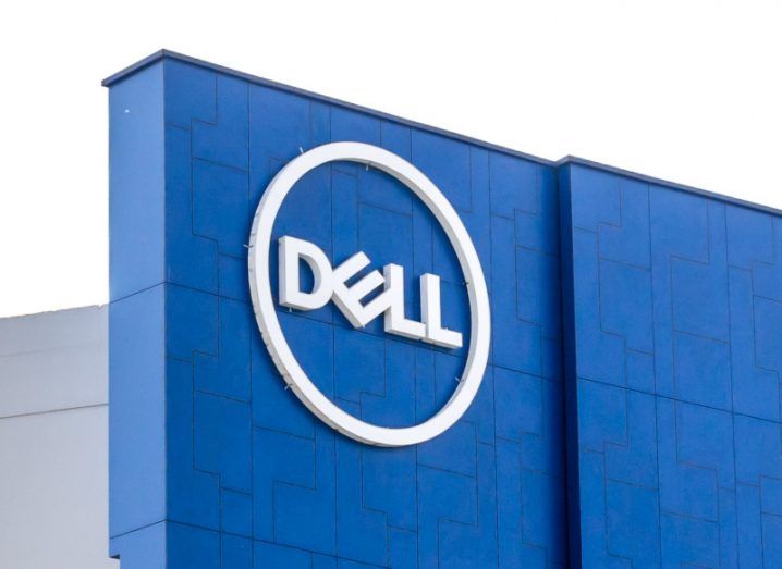 The Dell Technologies logo on a blue building, with a grey sky in the background.