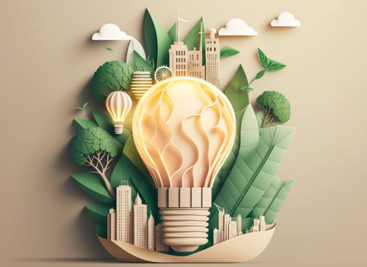 Paper cut out image style of light bulb with green eco city with green trees and buildings and clouds in beige colours.