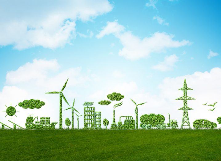 Conceptual image of industry including fishing, wind turbines, factories, a lorry, a telecoms mast, a car with trees and birds all in leafy green with a blue sky and white clouds in the background.