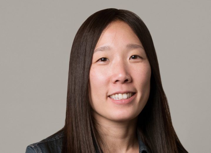 A woman with long hair smiles at the camera. She is Sandy Jen, CTO of Honor Technology.