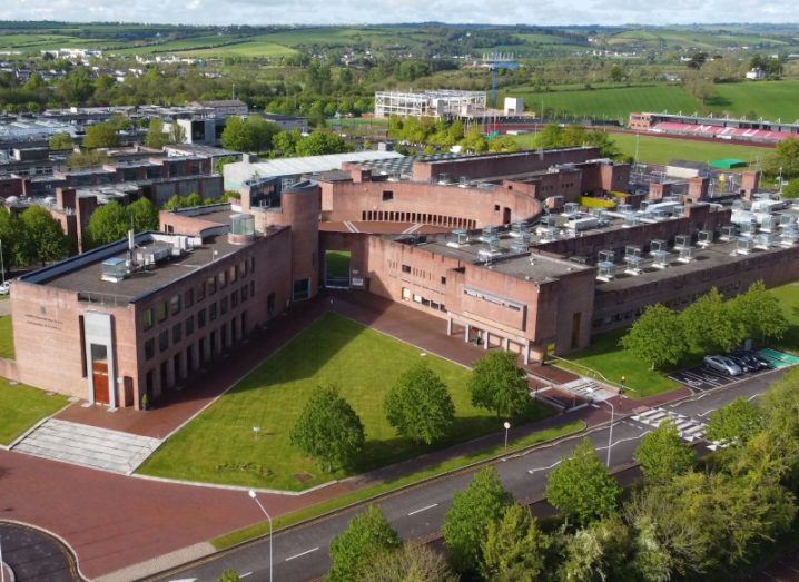 An aerial view of MTU's Bishopstown Campus in Cork, with green fields and a cloudy sky in the distance.